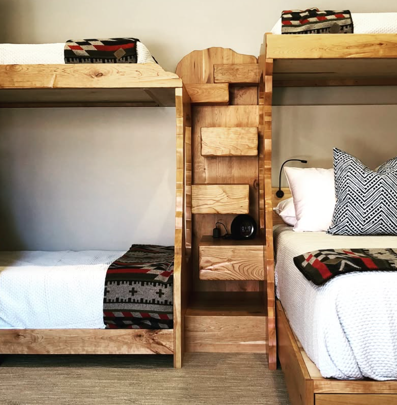 Wooden bunk bed with storage drawers in a room setting.